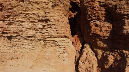 Flat rock formation Qarraba peninsula, close up on the cracked limestone where climbers can climb on the top. Ghajn Tuffieha , Qarraba peninsula, aerial close up. High quality photo