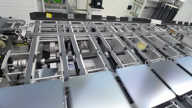 Photovoltaics production process solar panel assembly line operated by high tech robot arms in modern sustainable factory.