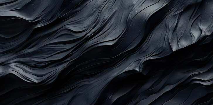 obsidian texture of black and grey marbled fabric on a black background