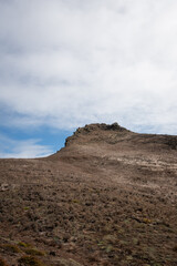 Rocky peak of a mountain against the cloudy sky