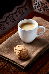 Cup of coffee on wooden background. Close up.