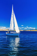 Sailboat at the coast on a beautiful summer day