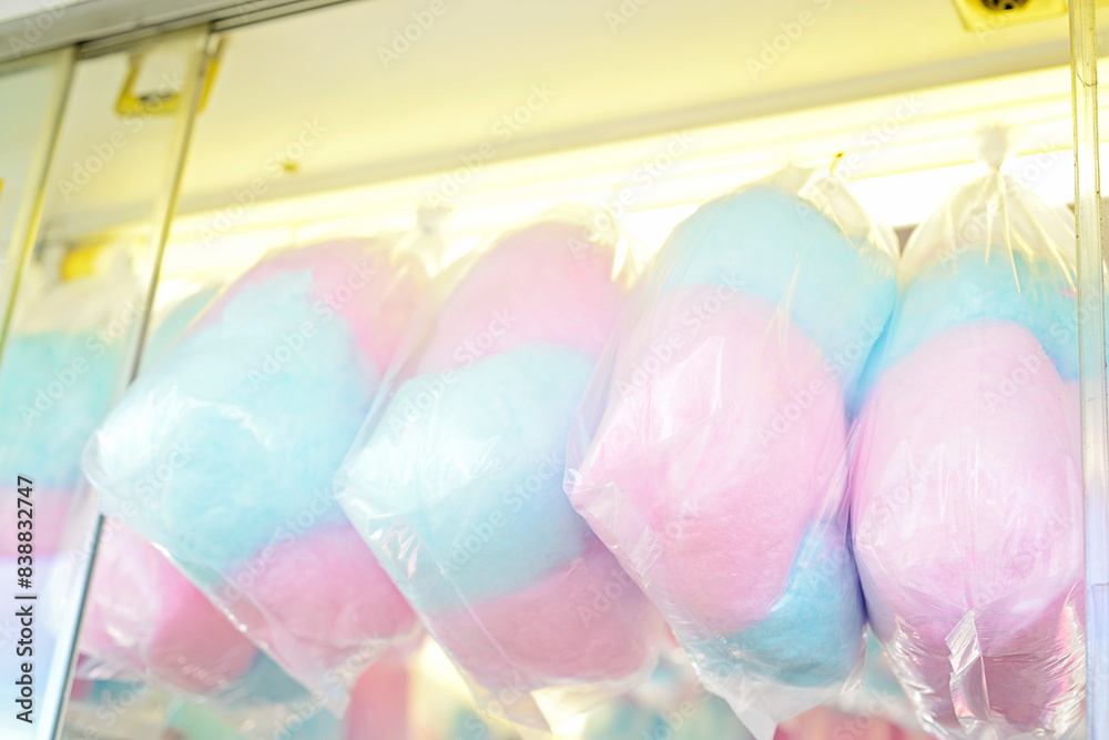 Wall mural Colorful bags of cotton candy on display at a carnival, pink and