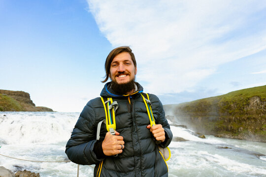 Man tourist in Gullfoss waterfall, in Iceland.