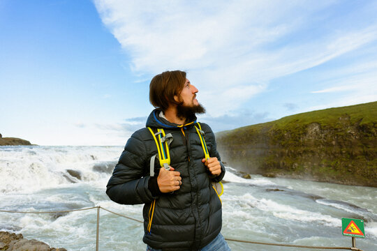 Man tourist in Gullfoss waterfall, in Iceland.