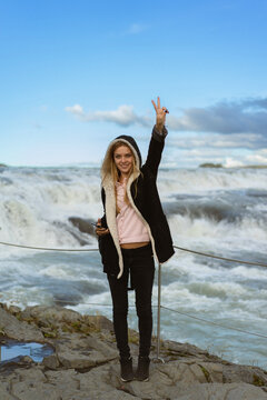 Woman tourist in Gullfoss waterfall, in Iceland.