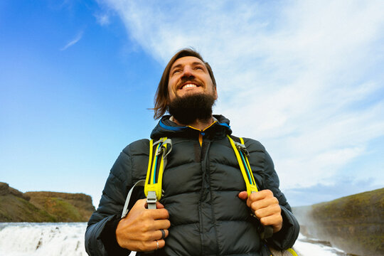Man tourist in Gullfoss waterfall, in Iceland.