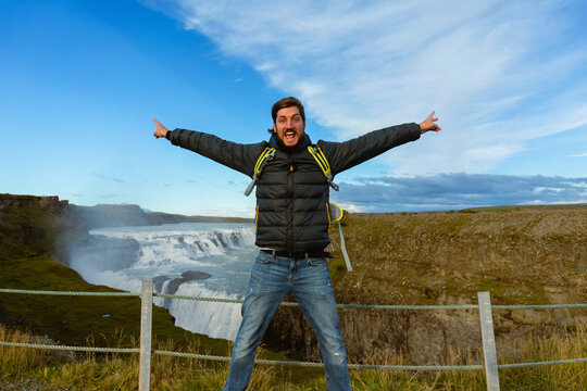 Man tourist in Gullfoss waterfall, in Iceland.