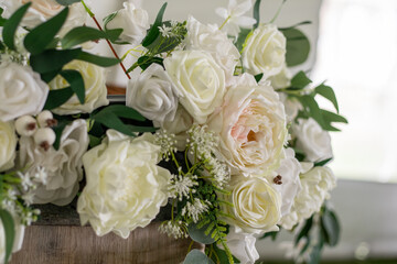 Close-up of white and pale pink roses with green foliage