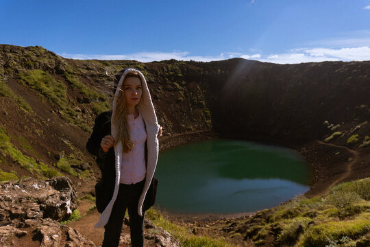 Woman traveler on the slope of Kerid crater lake.