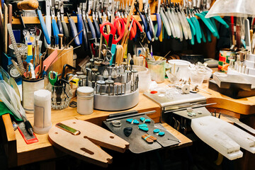 Jewelry makers bench with jewelry making tools and equipment