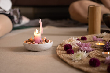 A pink burned down candle in a meditation environment