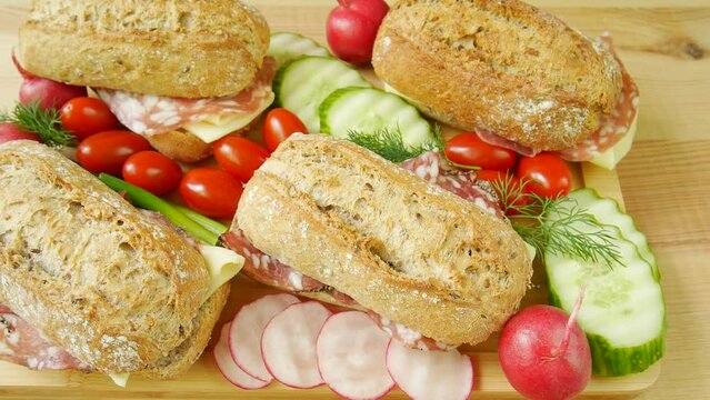 Sandwiches with cold cuts on a chalkboard.
