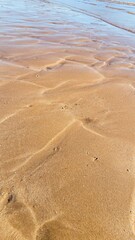 Wave sculpted ripples in the golden sand on this perfectly patterned beach.