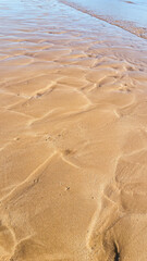 Wave sculpted ripples in the golden sand on this perfectly patterned beach.