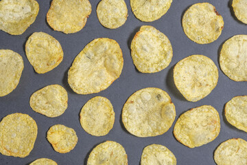 Potato chips on dark background.