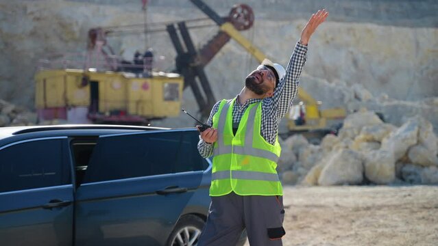 Funny industrial worker dancing at quarry