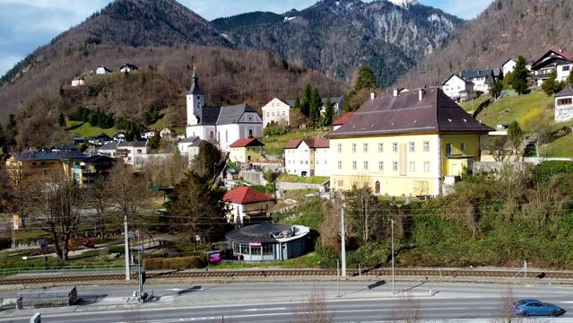 Wonderful view of Ebensee in Salzkammergut, Upper Austria with church, vehicles, and clear sky, daytime