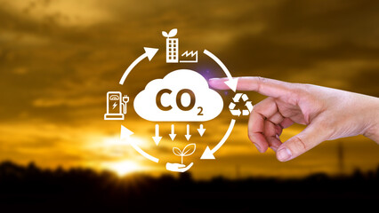 Hand holding CO2 reducing virtual icon for decrease carbon dioxide emission, carbon footprint and...