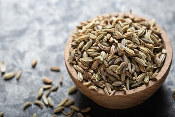 Indian spice fennel in wooden bowls close-up on gray background, macro shot