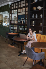 A networker woman working with the laptop in a hotel bar