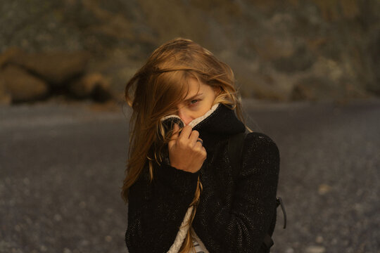 Woman in the columns of the Reynisfjara on Reynisdrangar beach.