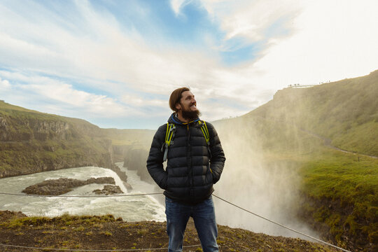 Man tourist in Gullfoss waterfall, in Iceland.
