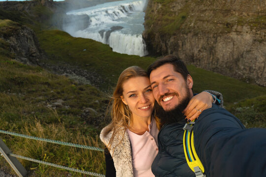 Couple of tourists at Gullfoss waterfall, Iceland.