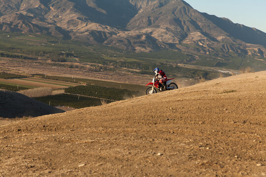 Skilled father and son riding dirt bike together in Santa Paula.
