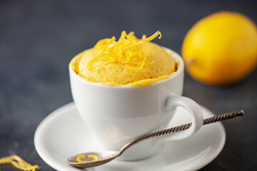 Lemon cupcake in a white mug. Easy homemade dessert. Mug cake