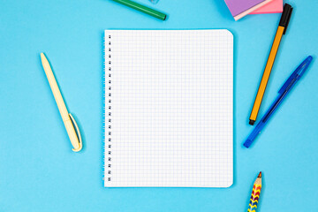 Notebook white sheet cage place text mockup blue background, different pens, stickers for notes....