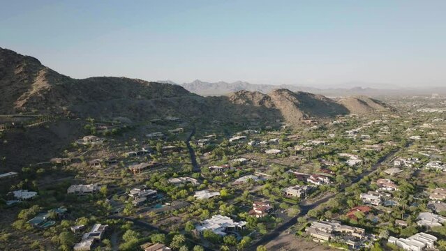 Wealthy mansions on the hills of Mummy Mountain, Paradise Valley in Arizona USA during sunny day. Drone view.
