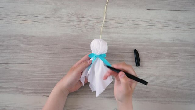 making a little handmade doll called a teru teru bozu to wish for good weather tomorrow. てるてる坊主を作る	