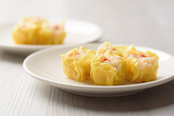Shrimp shumai, wonton stuffed or dumplings, Asian cultural food on white table background