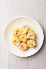Shrimp shumai, wonton stuffed or dumplings, Asian cultural food on white table background