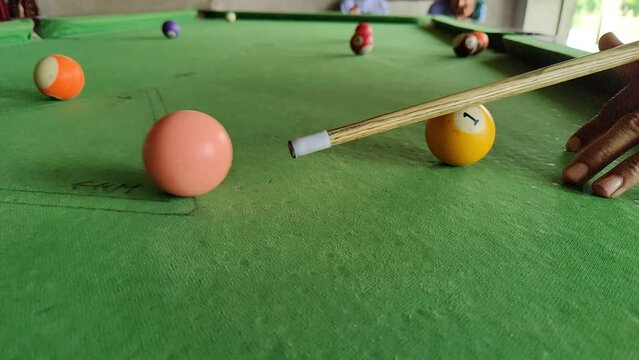 People playing 8-ball pool billiards on green table with opening break shot, American pool. Pool is a classification of cue sports. balls on table sport game set known as eight ball pool. slow-motion
