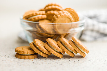 Golden Brown Sandwich Cookies in a Clear Bowl on a Kitchen Counter