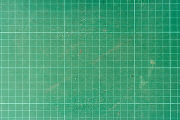 Background and textured of cutting mat green color. Used paper cutting mat.