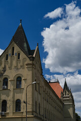 Fototapeta premium Architecture of the small town Zrenjanin in Serbia, Vojvodina district. An old shabby building with carved patterns and a gabled roof.