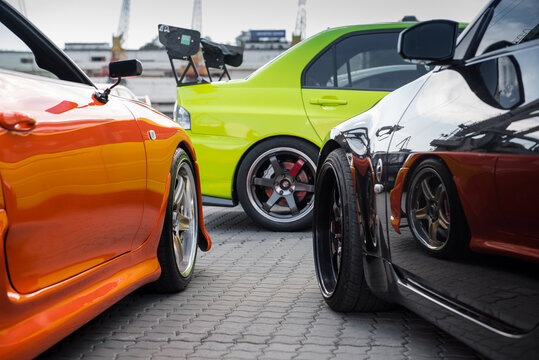 JDM car meet - Japanese cars owners gathering - orange Toyota Supra, Black Nissan 350z and lime Green Mitsubishi Lancer Evo. Odesa, Ukraine - May 07 2016.