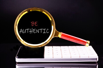 Be Authentic written appeared through a magnifying glass on a black background standing on a...