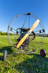 Paragliding machine for paragliding flights on green grass. Preparing paralet with a gasoline engine for flights. Extreme sports