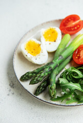 Fresh Spring Salad With Boiled Eggs, Asparagus, and Tomatoes on a Bright Day
