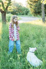 Fototapeta premium A child with a dog in nature