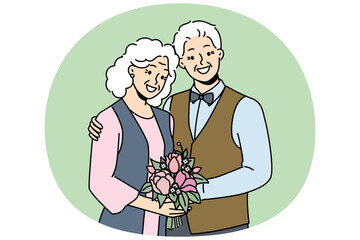 Elderly couple in love smiles rejoicing at happy family life, poses for picture on eve of golden wedding. Elderly family of man and woman hugging each other, looking at screen and laughing