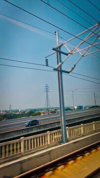 From inside the KCIC Jakarta - Bandung express train, Indonesia as it passes through the elevated highway and through the city.