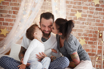 Happy family at Christmas time in bed