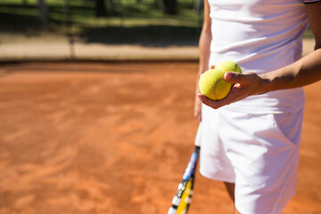 Man holding tennis balls during tennis match