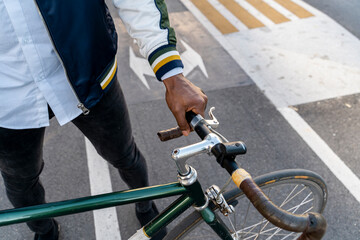 Close-up of casual businessman with bicycle in the city