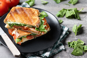 Healthy spinach, tomato and cheese sandwich on wooden table. Copy space